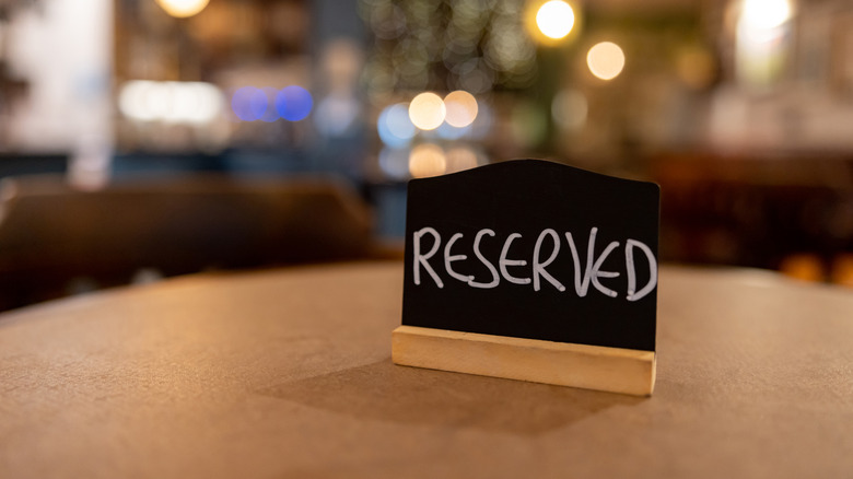 Close up of "reserved" sign on a pub table