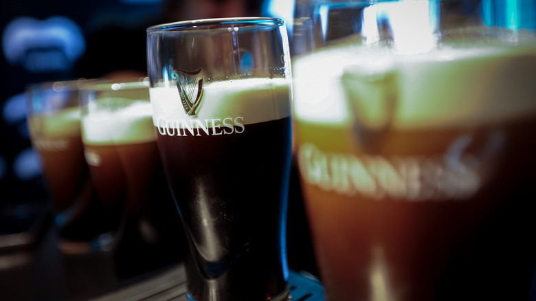 Close up of pints of Guinness lined up on the bar