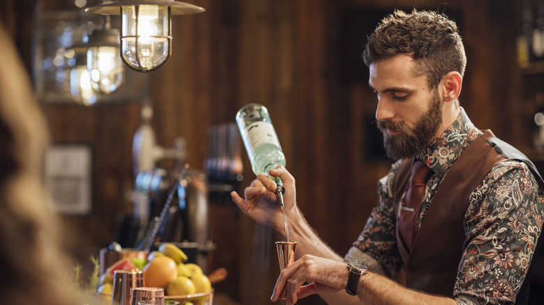 Bartender serving drinks in a classic British pub
