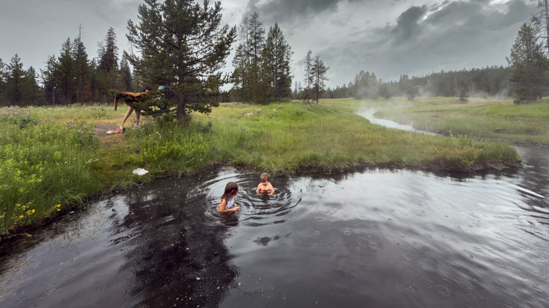 Two kids playing in a hot spring in Grand Teton National Park