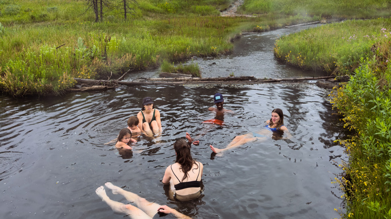 People enjoying a natural hot spring in Grand Teton National Park