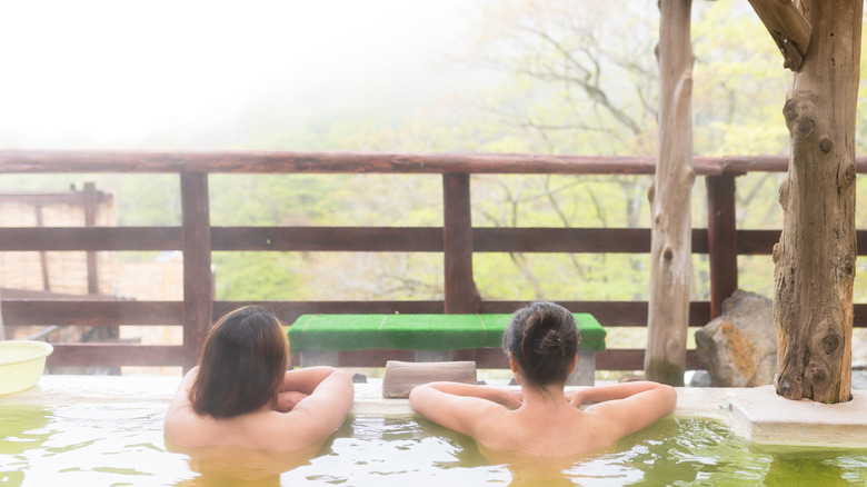 Two people soaking in a hot spring