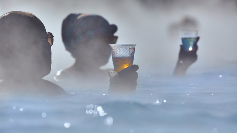 People drinking in a thermal bath
