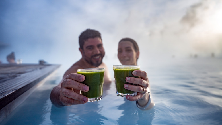 A couple drinking fruit juice while enjoying a thermal bath