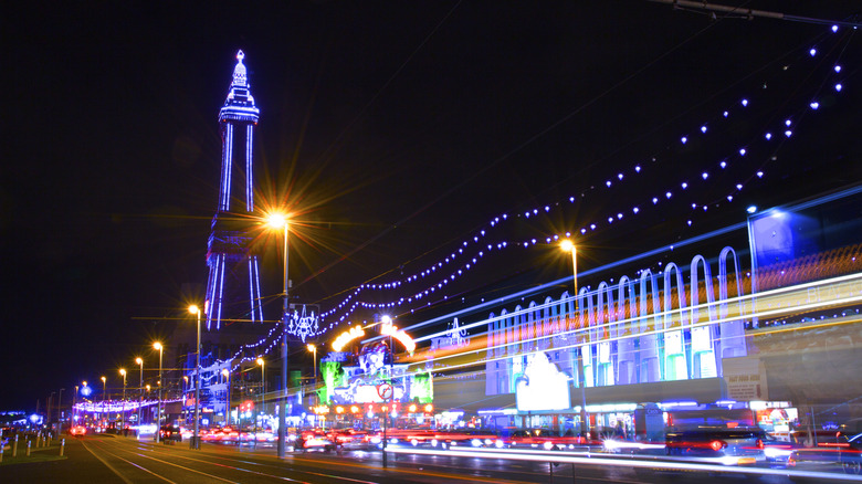 The Famous Blackpool Tower and lights along the stretch of promenade known as the Golden Mile in Blackpool, Lancashire at night,