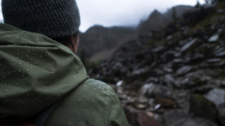 Hiker in a rain jacket hiking in rainy weather at Banff National Park