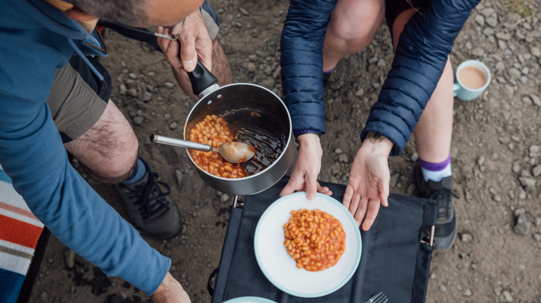 People cooking while camping