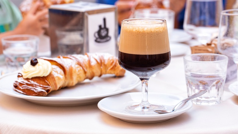 Typical Italian breakfast table with coffee and pastry