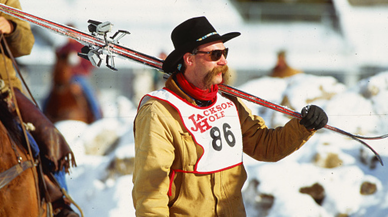 A cowboy carries his skies at the Jackson Hole Cowboy Ski Challenge