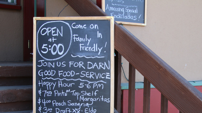 A restaurant with its specials posted on a blackboard
