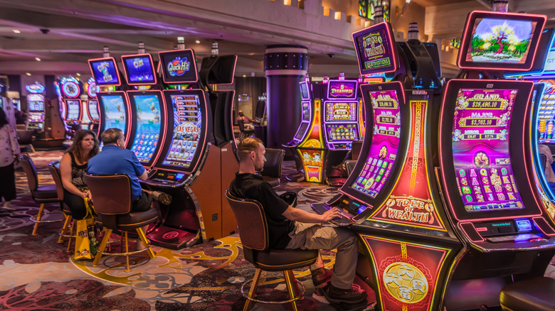 man playing slot machines in vegas casino