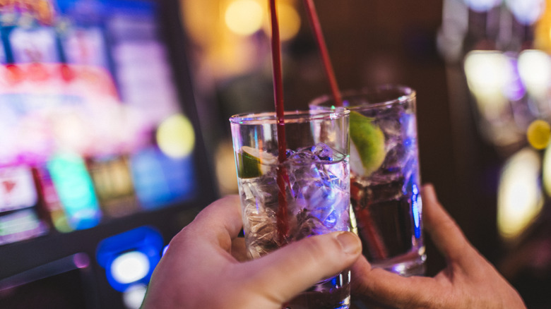two people cheers drinks in vegas casino