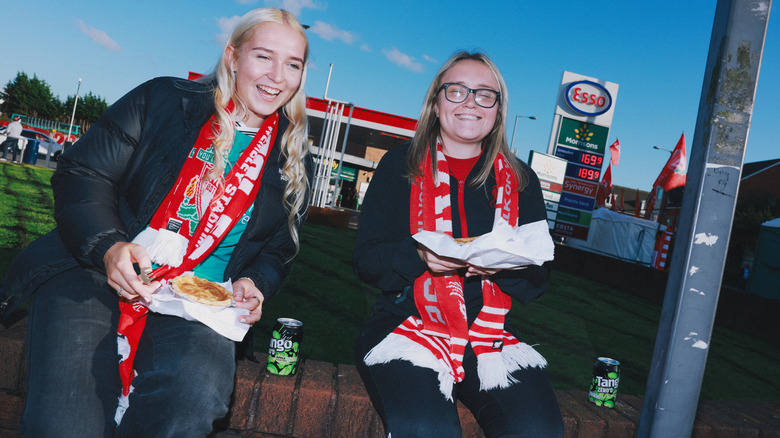 Liverpool fans pose with a scouse pie