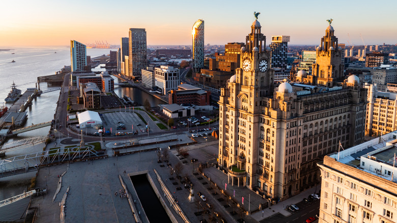 Aerial view of Liverpool cityscape at sunset, featuring the iconic Royal Liver Building