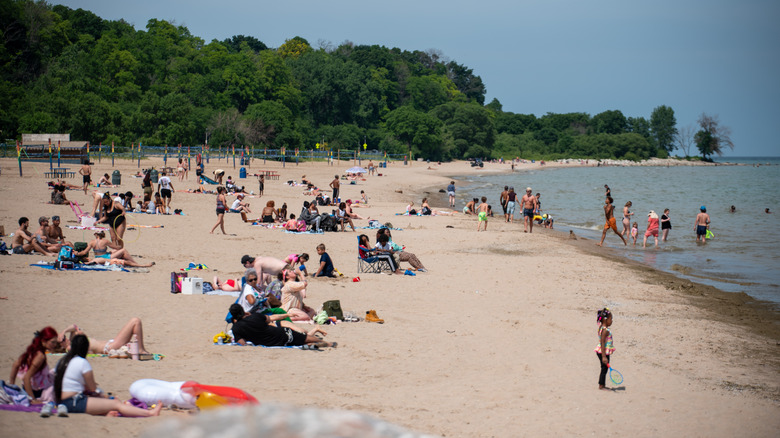 People soak up the sun at Bradford Beach in the summer in Milwaukee, Wisconsin