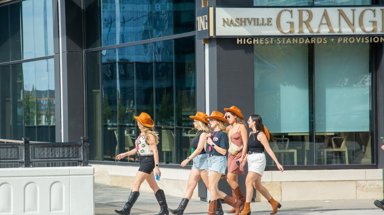 A group of women wearing cowboy hats and boots in Nashville