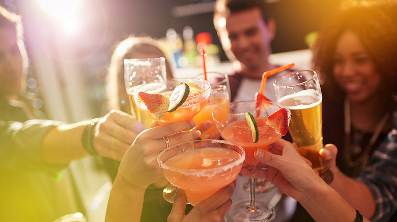 A group of people holding alcoholic drinks