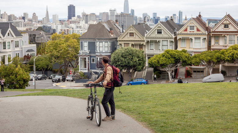 A young man exploring San Francisco with a bicycle