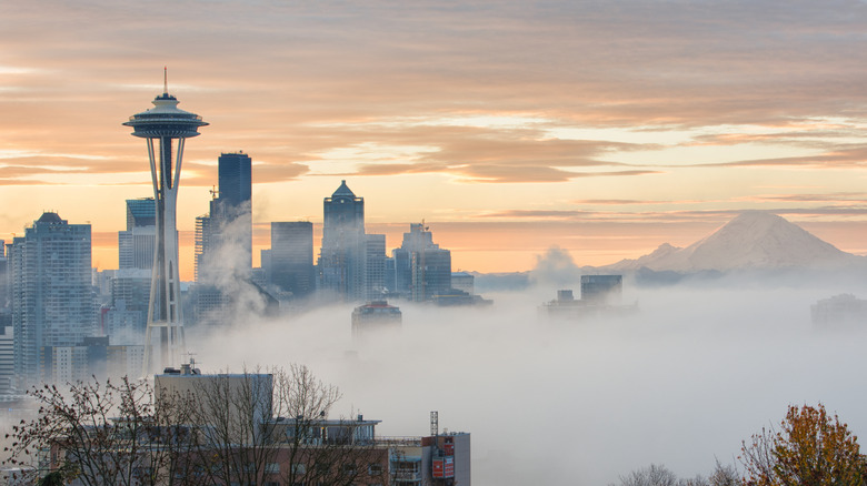 Mist over downtown Seattle near the Space Needle and mountain in the background