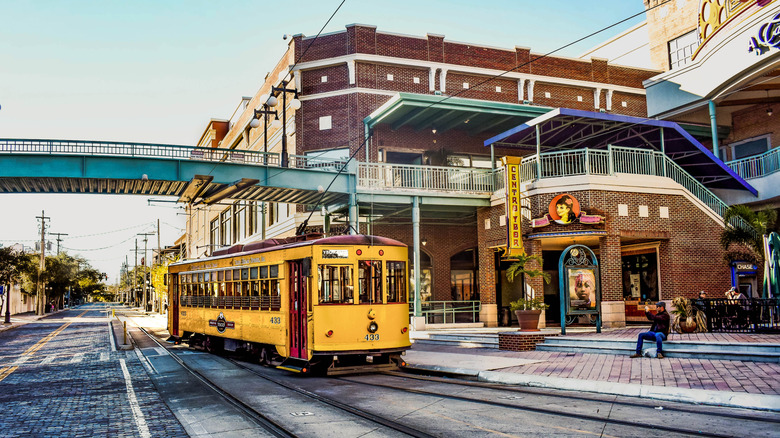 Yellow streetcar driving through Ybor City