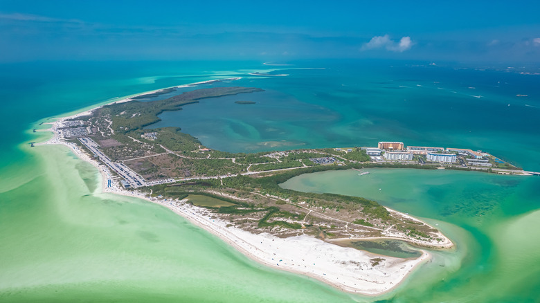 Aerial view of Honeymoon Island State Park with green and blue water and white sand