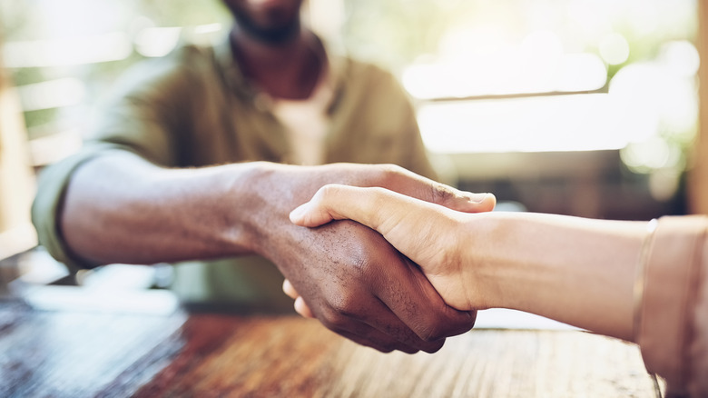 Cropped shot of two people shaking hands