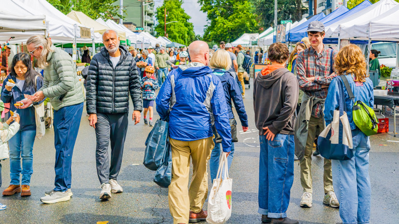 People wearing casual clothing at an outdoor market in Washington state