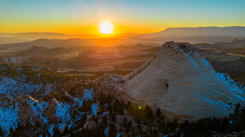 A Utah sunset in Zion National Park with Mountains near Wildcat Canyon, Kolob Canyon, winter snow and pine trees