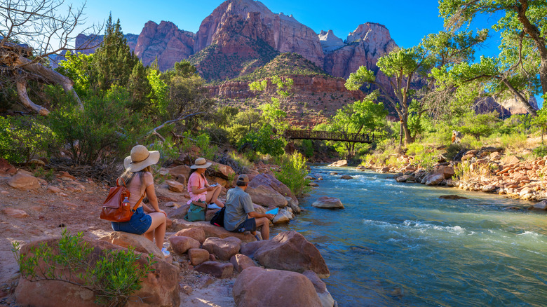 Family sitting by the Virgin River, Pa'rus Trail, Zion National Park