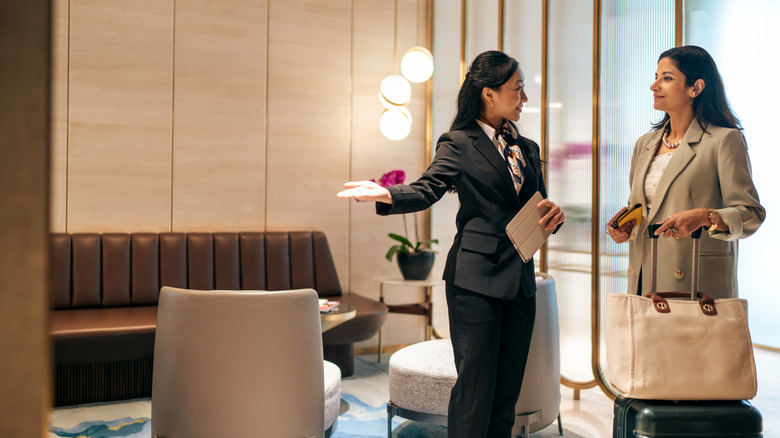 Staff member and passenger at airport lounge