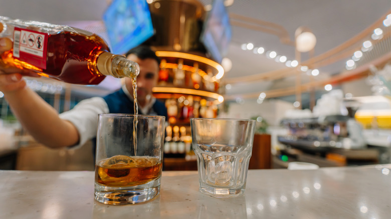 Bartender pouring a drink in airport bar