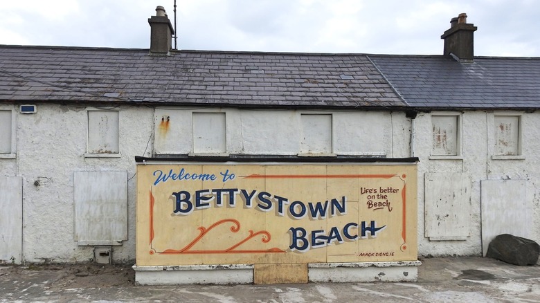 Handpainted Welcome to Bettystown Beach sign against an old building