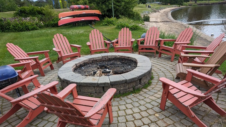 Red wooden chairs around fire pit at Lake Pleasant Lodge
