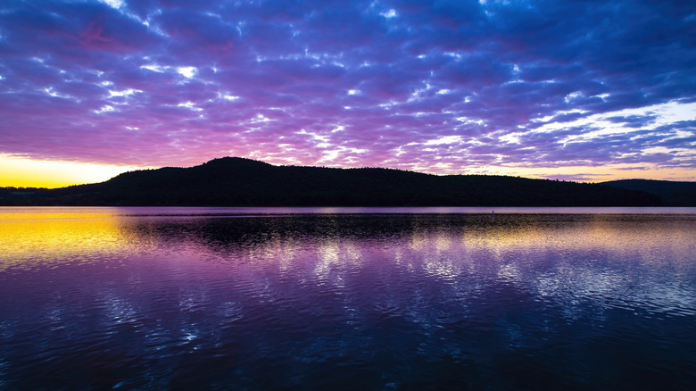 Otsego Lake at dusk under a purple and blue sky