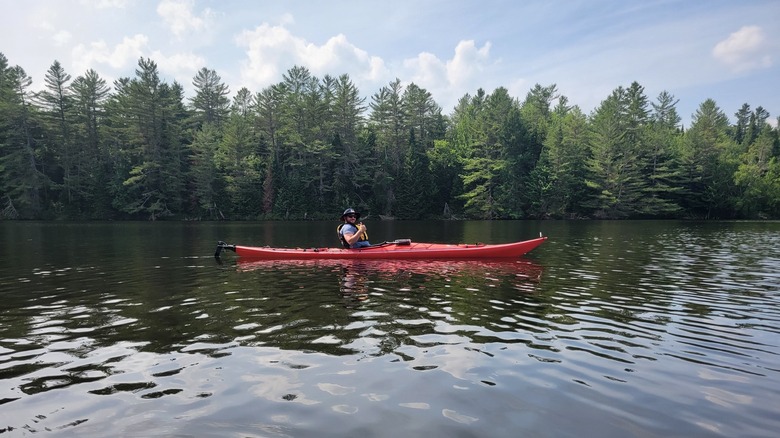 Person kayaking on Lake Kushaqua in afternoon