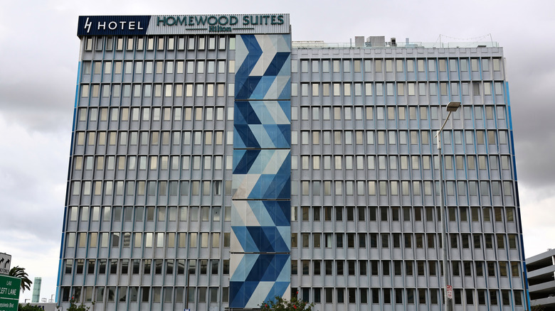 Facade of joint signage for H Hotel and Homewood Suites by Hilton at LAX on a cloudy day