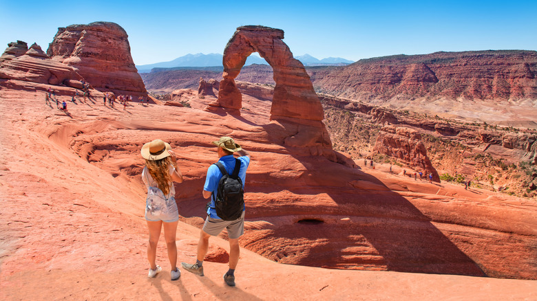 Hikers overlooking the arches at Moab National Park, Utah