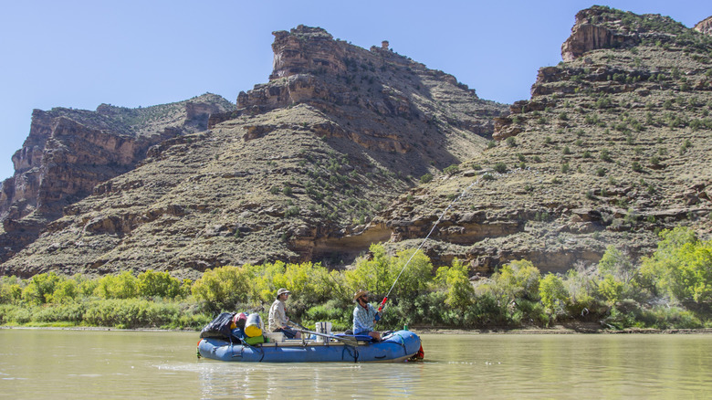 Two people fishing off a raft in Desolation Canyon on the Green River in Utah