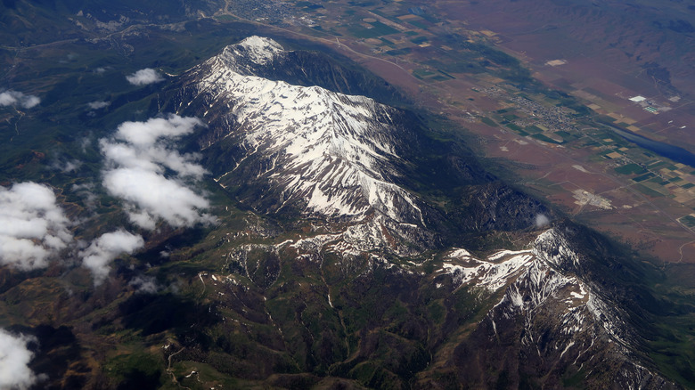 Aerial view of a snowcapped Mount Nebo with Mona, Utah in nearby during the day.