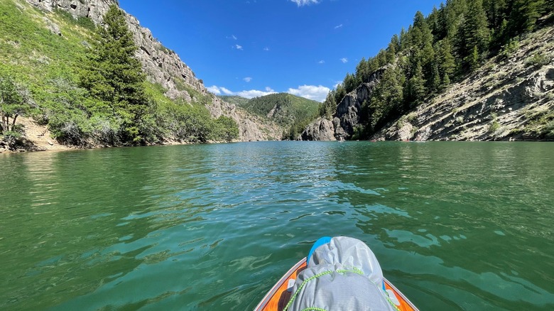 View from paddleboard in the middle of Causey Reservoir, surrounded by towering mountains