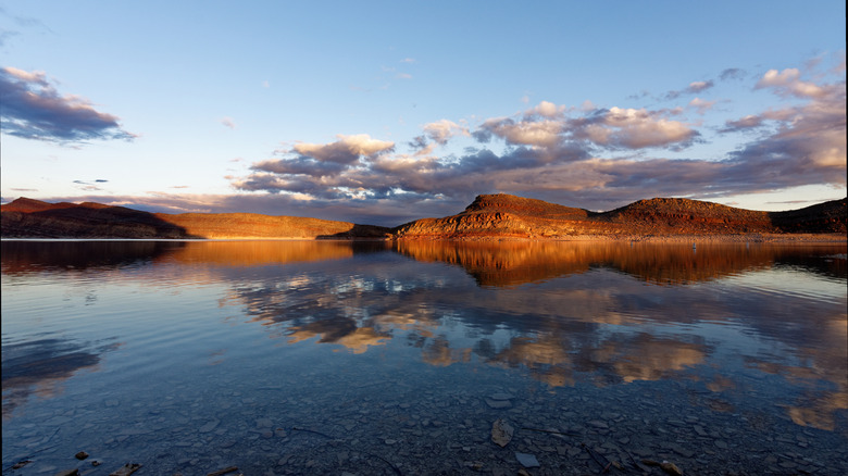 Quail Creek State Park, Utah, with the red rock mountains reflecting in the reservoir