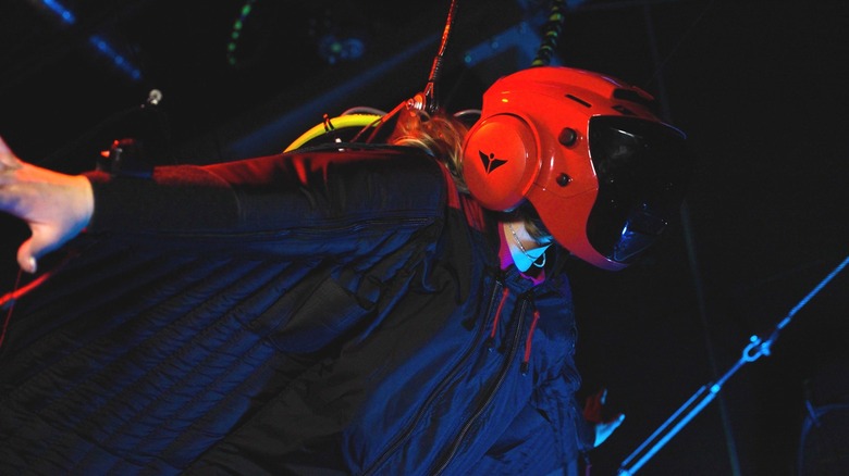 A person wearing a virtual reality helmet and wingsuit at JUMP in Bluffdale Utah