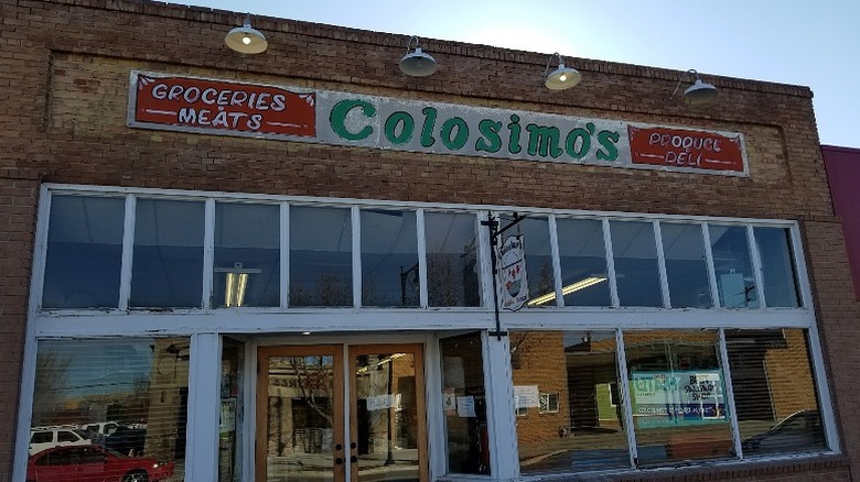 The historic brick facade of Colosimo's Original Standard Market & Sausage Factory in Magna, Utah.