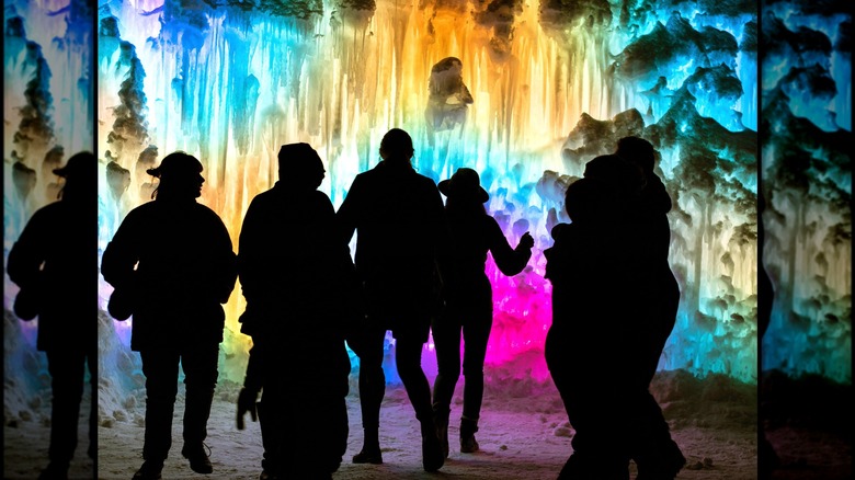 People in the colorful Ice Castles installation in Midway, Utah