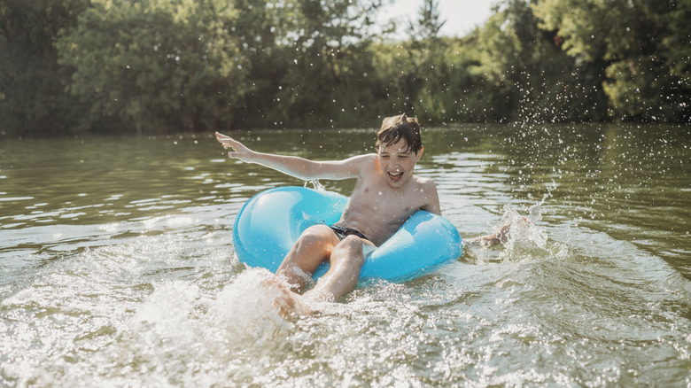 Boy tubing in a river