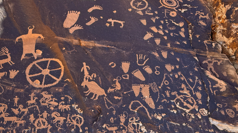 The sandstone monolith at Newspaper Rock, Utah, covered in petroglyphs.