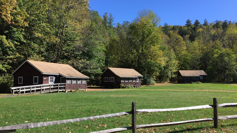 Wooden cabins on a grassy lawn at Camp Plymouth State Park, Vermont