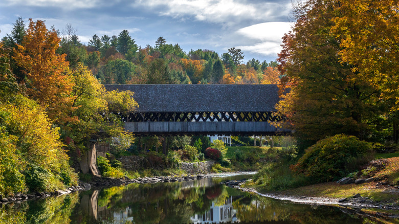 Side view of the Middle Covered Bridge crossing over the Ottauquechee River in Woodstock, Vermont