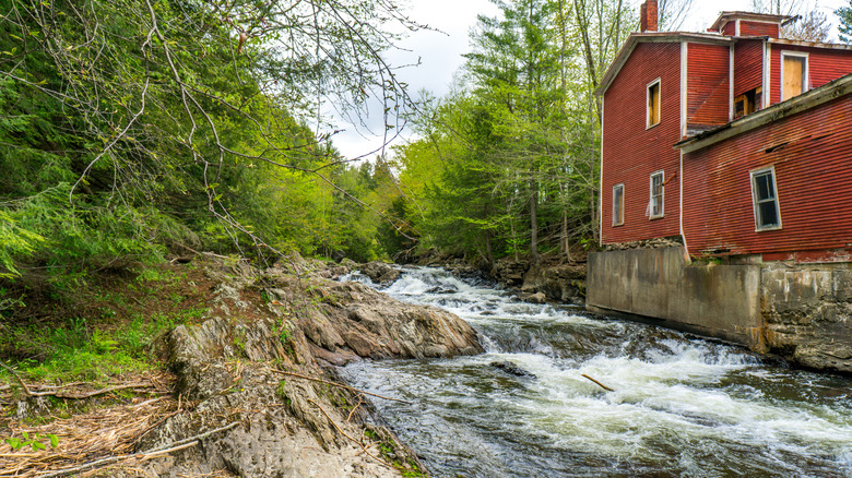 The Gihon River rushing past an old red mill in Johnson, Vermont