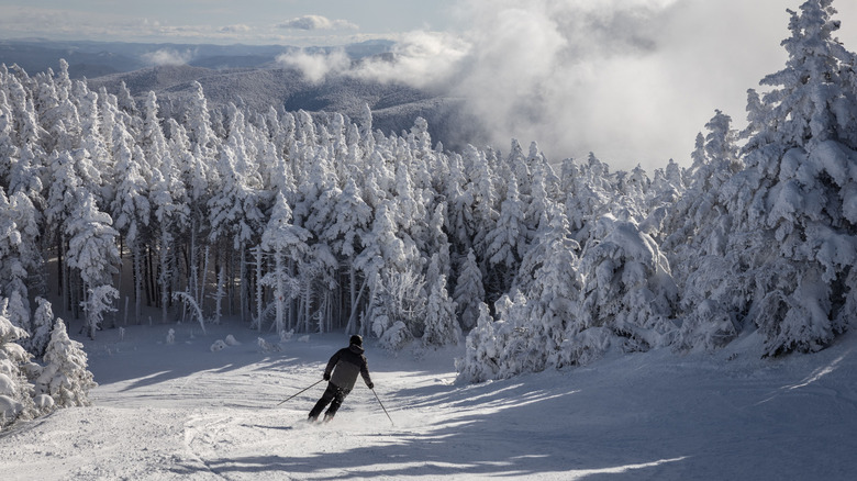 A person skis down snowy slopes in Vermont